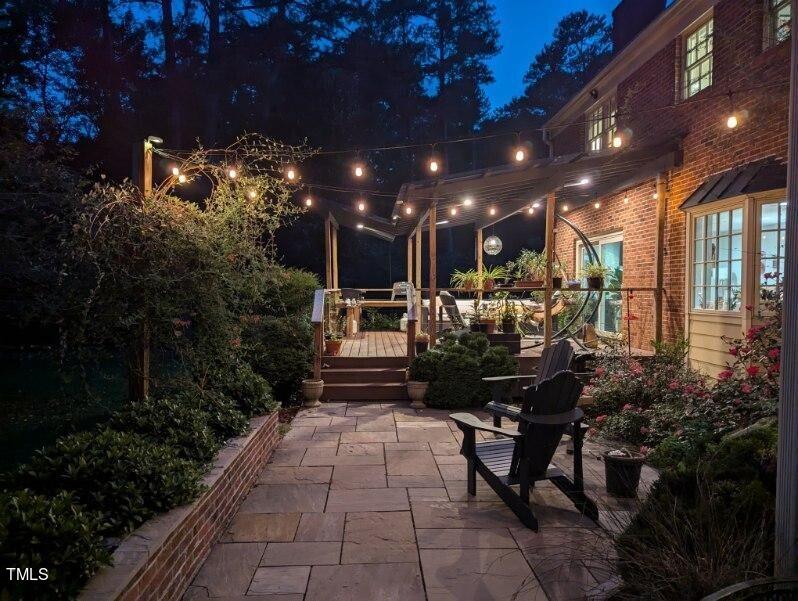 7214 Sunrise Road Chapel Hill, NC 27514 - Photo 51 of 61 a view of a patio with dining table and chairs with plants and a patio