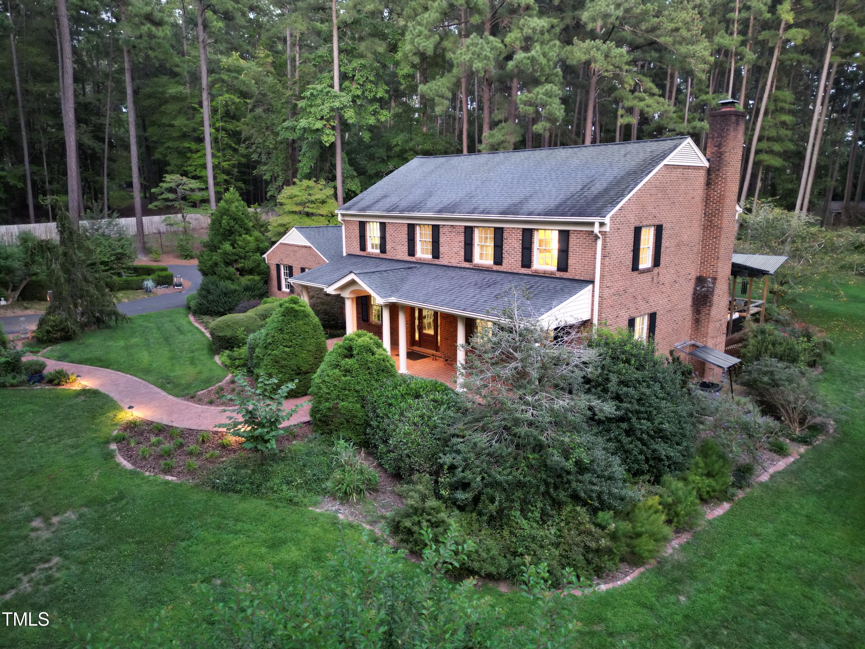 7214 Sunrise Road Chapel Hill, NC 27514 - Photo 61 of 61 a aerial view of a house next to a big yard and large trees