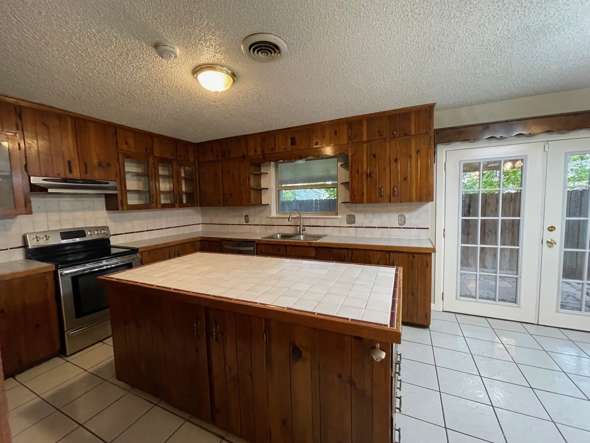 607 Pecan Street Del Rio, TX 78840 - Photo 2 of 10 a kitchen with stainless steel appliances granite countertop a stove a sink and a microwave