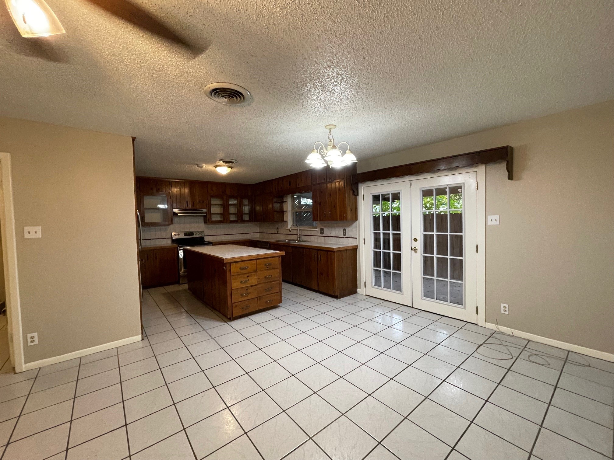 607 Pecan Street Del Rio, TX 78840 - Photo 4 of 10 a kitchen with stainless steel appliances kitchen island granite countertop a refrigerator and a sink