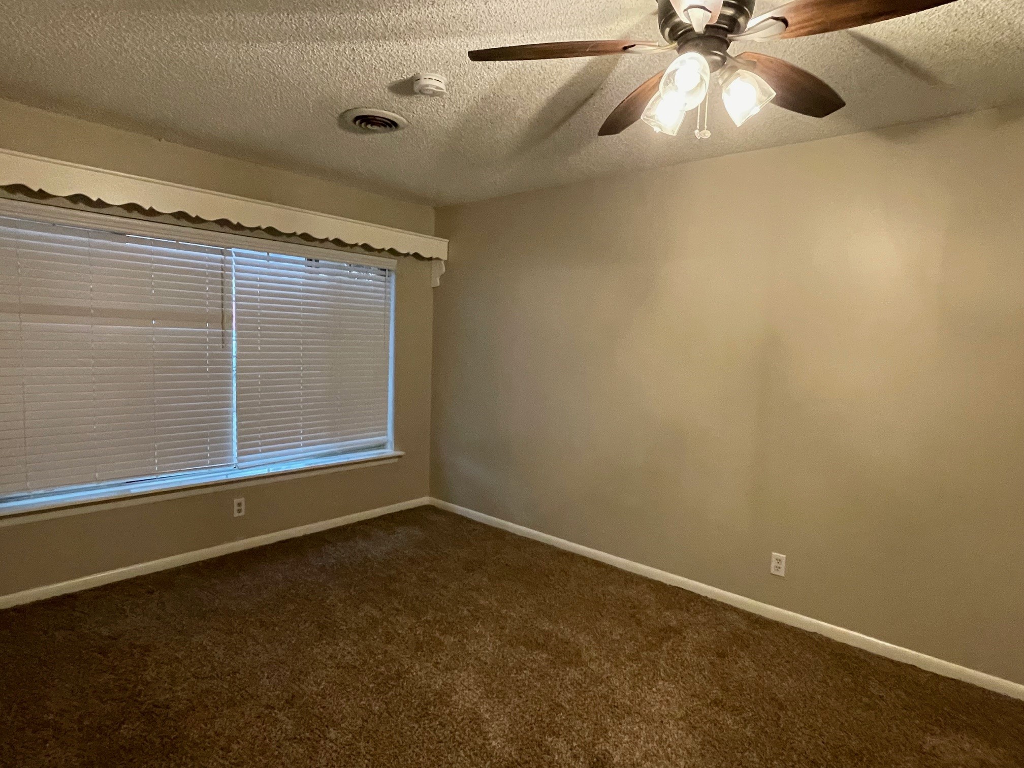 607 Pecan Street Del Rio, TX 78840 - Photo 9 of 10 en empty room with windows and fan