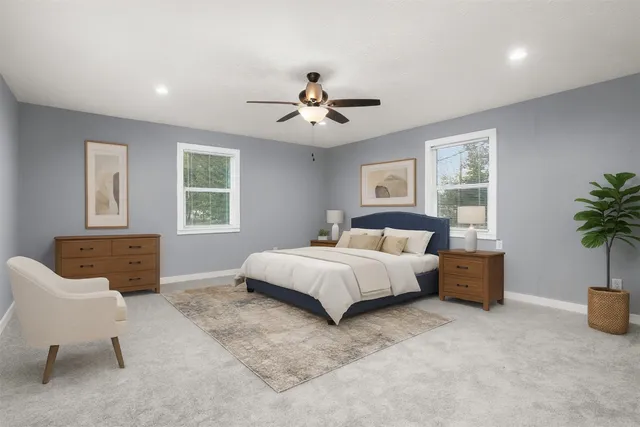 a spacious bedroom with a bed and a couch