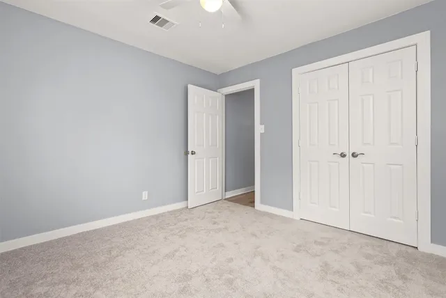 an empty room with closet area