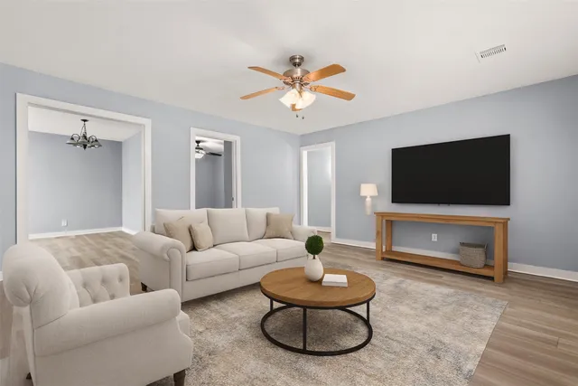 a living room with furniture and a flat screen tv