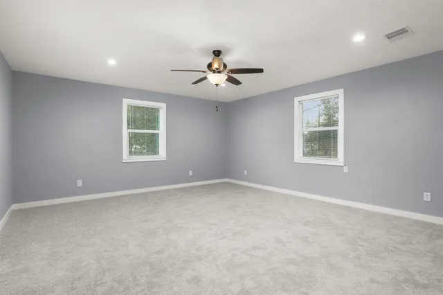 a spacious bedroom with a bed and a couch