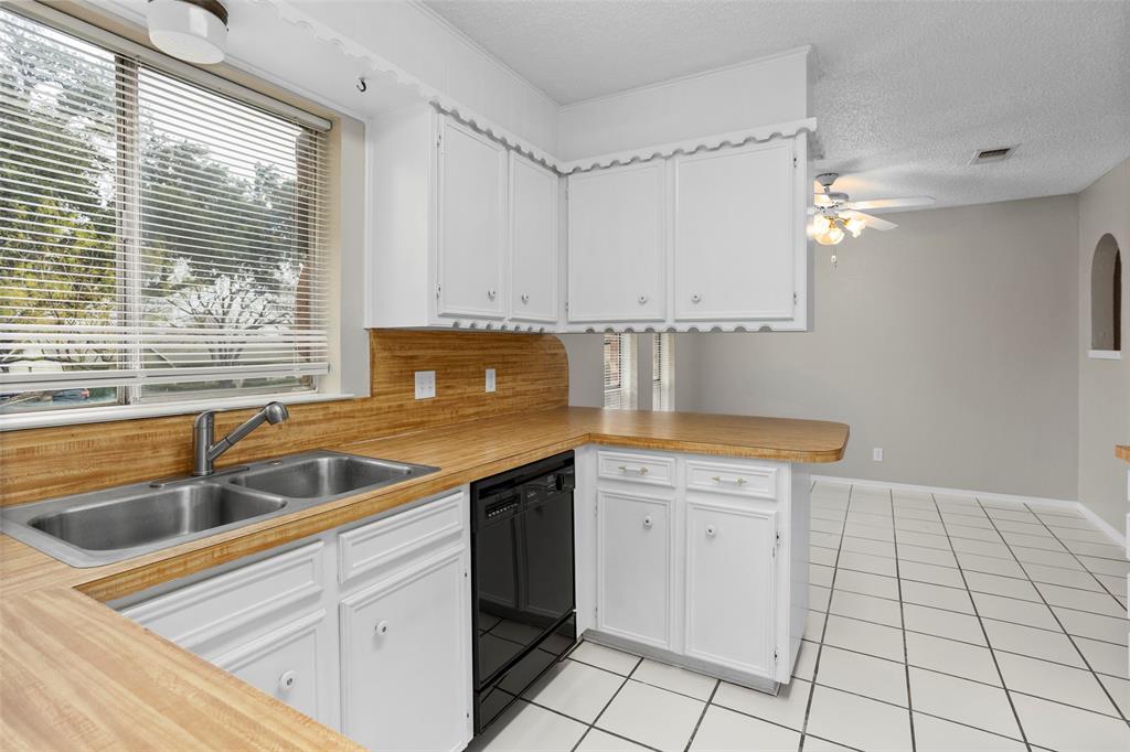 1024 Edgewood Trail Benbrook, TX 76126 - Photo 15 of 28 a kitchen that has a sink and a stove