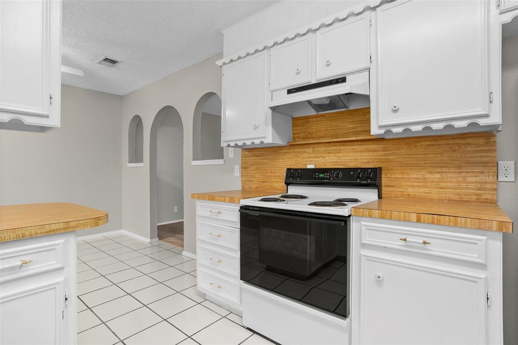 1024 Edgewood Trail Benbrook, TX 76126 - Photo 16 of 28 a kitchen with granite countertop white cabinets and white appliances