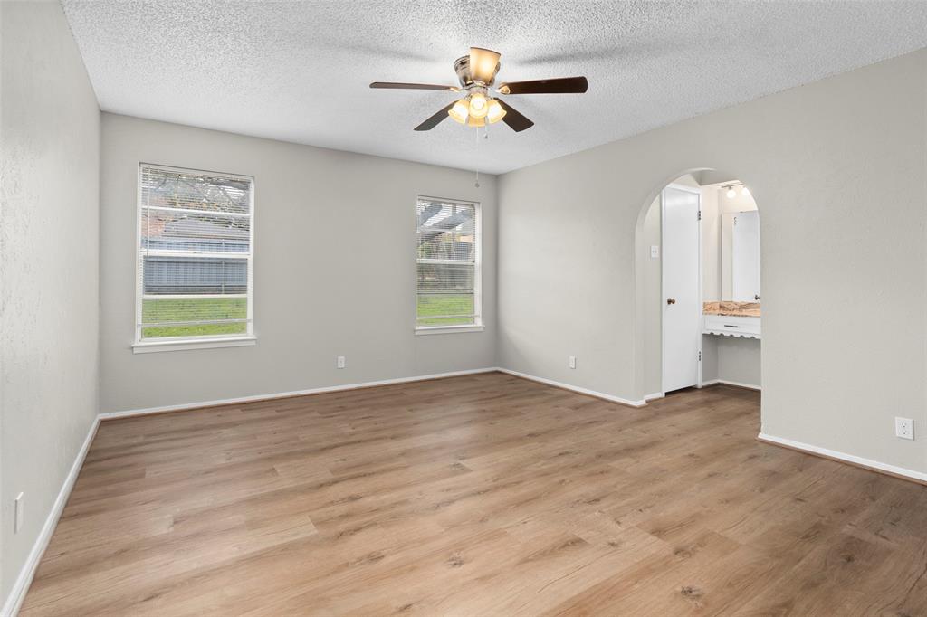 1024 Edgewood Trail Benbrook, TX 76126 - Photo 18 of 28 an empty room with windows and ceiling fan