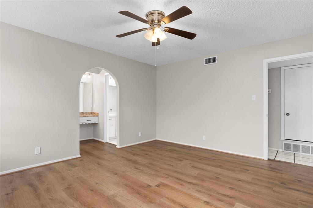 1024 Edgewood Trail Benbrook, TX 76126 - Photo 19 of 28 an empty room with wooden floor and a ceiling fan