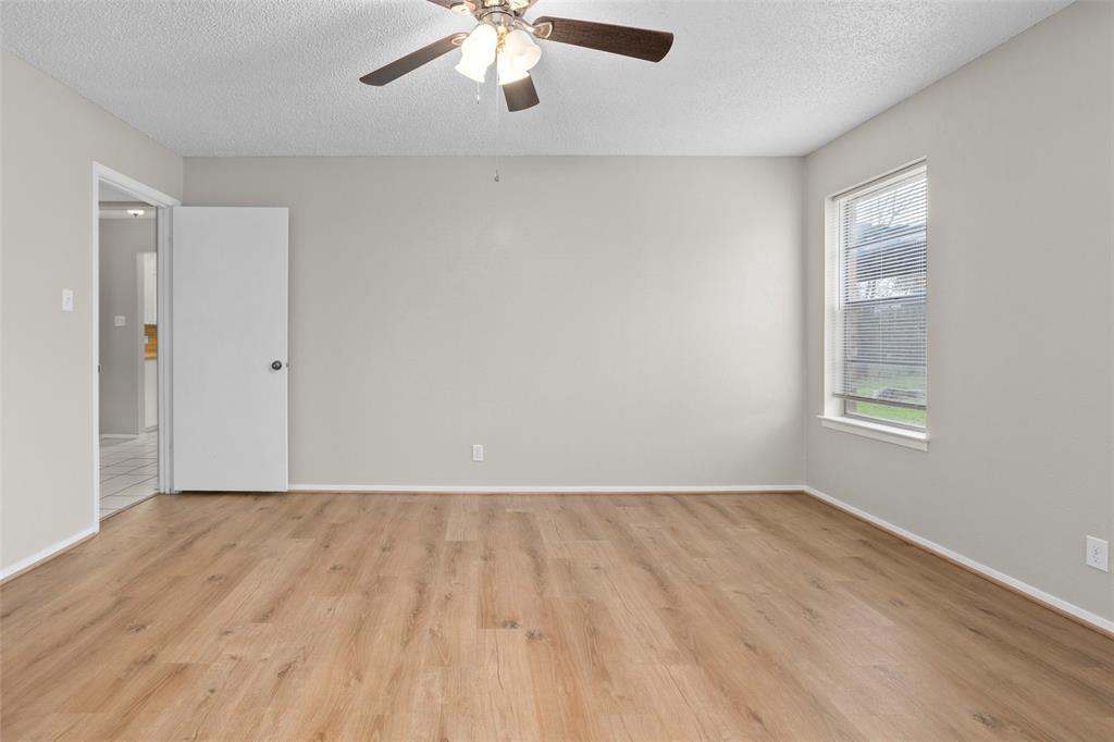 1024 Edgewood Trail Benbrook, TX 76126 - Photo 20 of 28 wooden floor in an empty room with a window