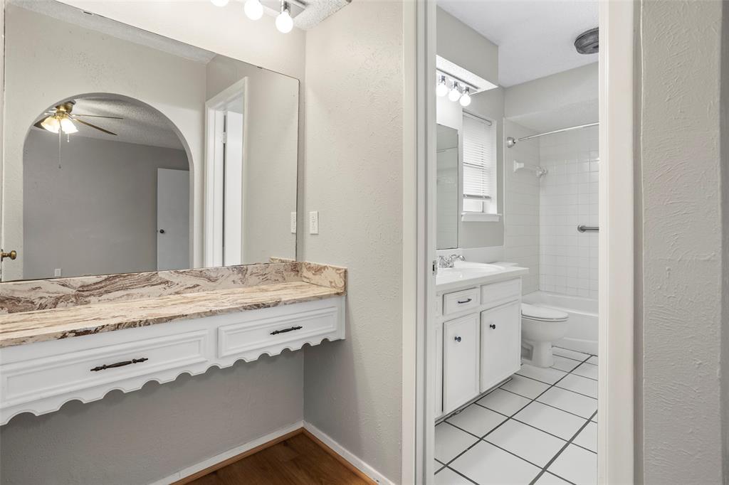 1024 Edgewood Trail Benbrook, TX 76126 - Photo 21 of 28 a spacious bathroom with a granite countertop sink and a mirror