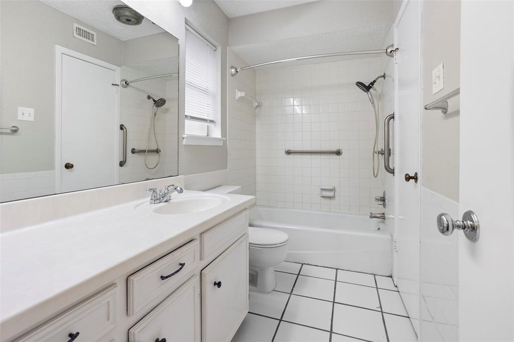 1024 Edgewood Trail Benbrook, TX 76126 - Photo 22 of 28 a bathroom with a granite countertop sink a toilet and shower