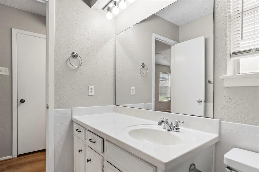 1024 Edgewood Trail Benbrook, TX 76126 - Photo 23 of 28 a bathroom with a sink and a mirror