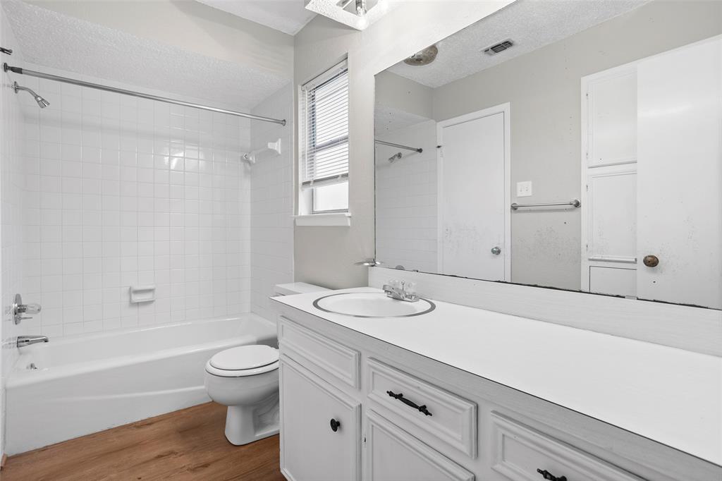 1024 Edgewood Trail Benbrook, TX 76126 - Photo 26 of 28 a bathroom with a sink a toilet and shower