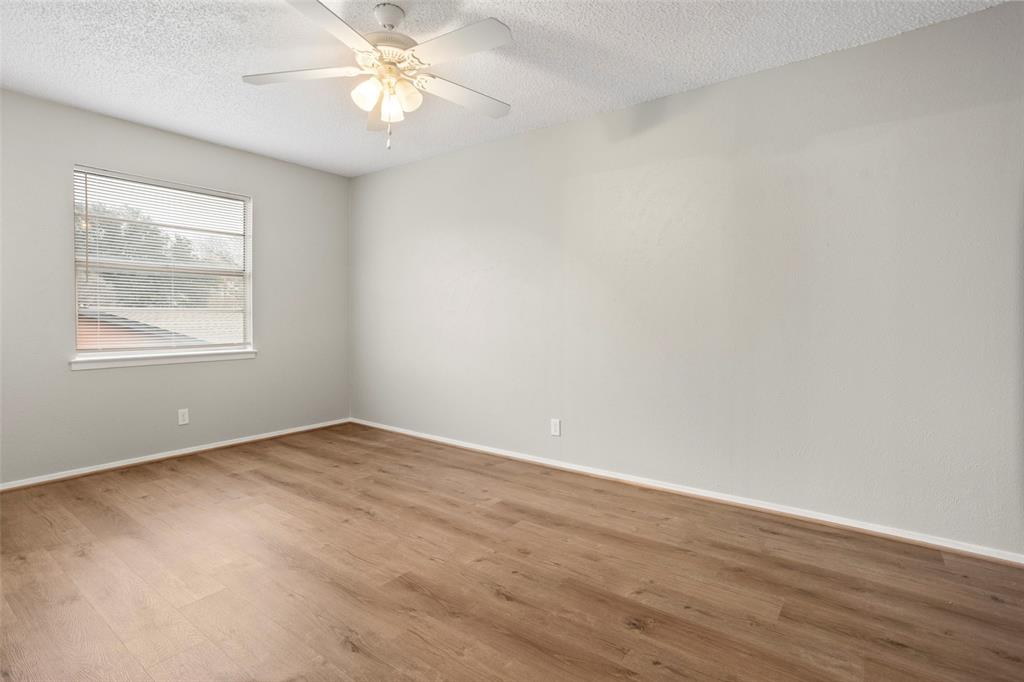 1024 Edgewood Trail Benbrook, TX 76126 - Photo 27 of 28 an empty room with wooden floor closet and windows