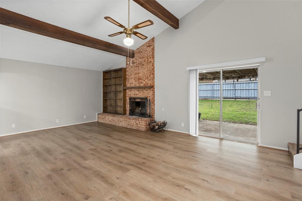 1024 Edgewood Trail Benbrook, TX 76126 - Photo 4 of 28 an empty room with wooden floor fireplace and windows