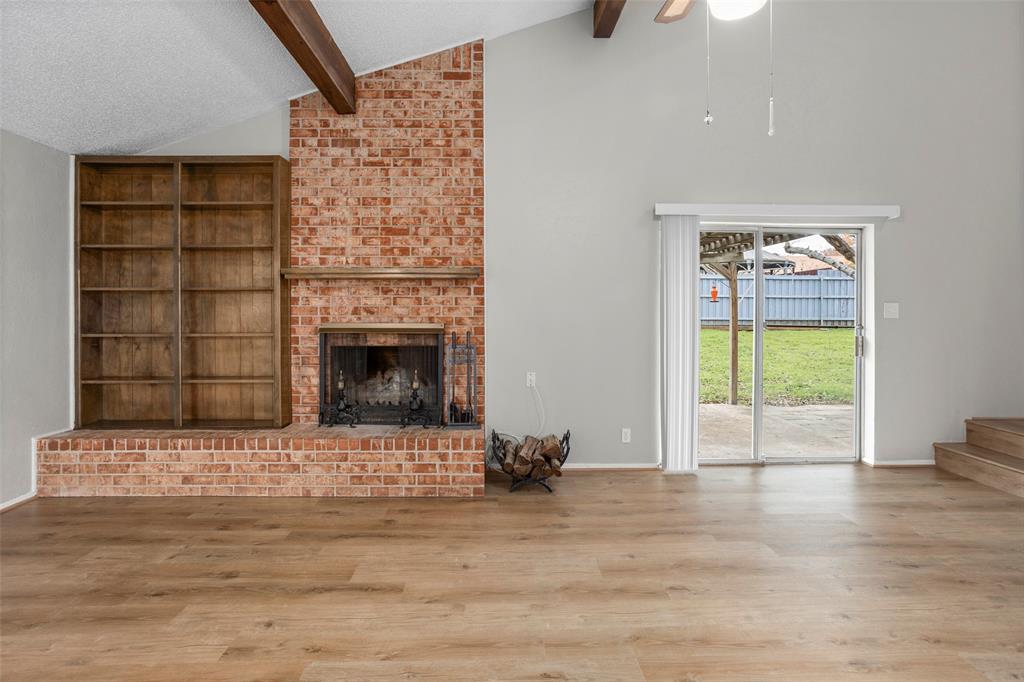 1024 Edgewood Trail Benbrook, TX 76126 - Photo 6 of 28 a view of an empty room with a window and a fireplace