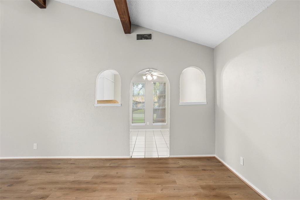 1024 Edgewood Trail Benbrook, TX 76126 - Photo 9 of 28 a view of a livingroom with wooden floor and a ceiling fan
