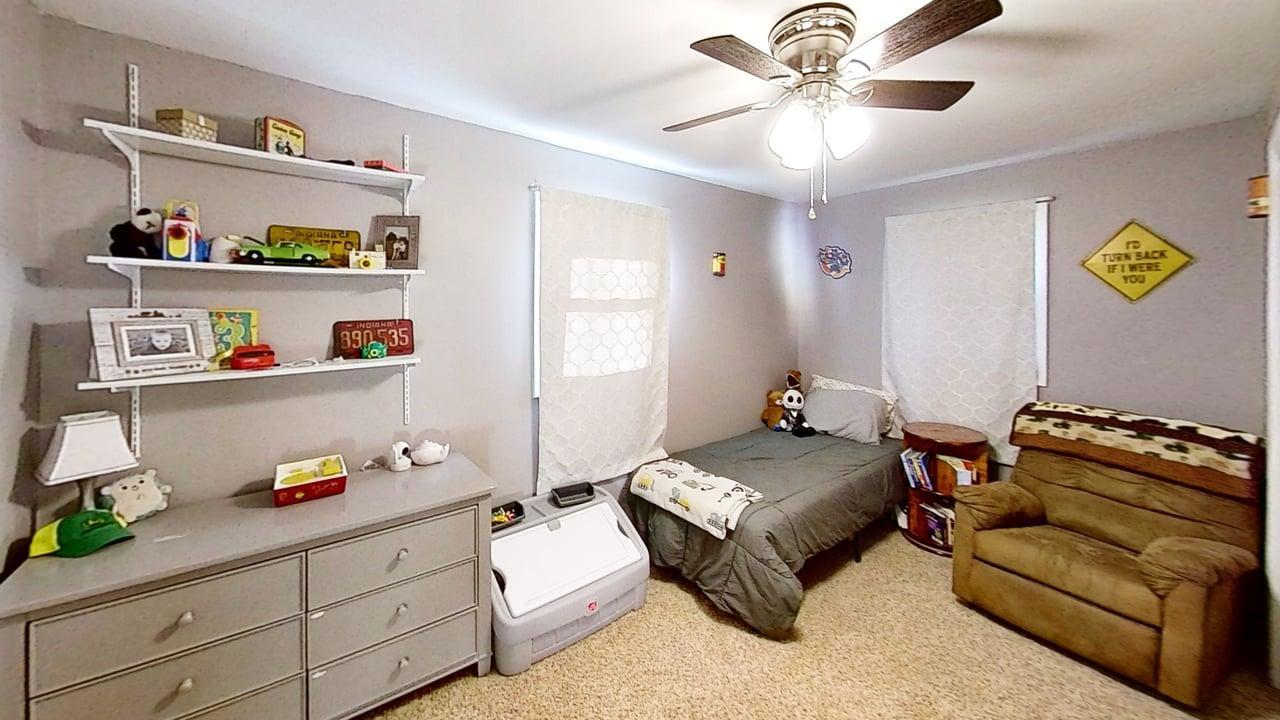 17 Greenlawn Drive Kankakee, IL 60901 - Photo 21 of 29 a bedroom with a bed and a chandelier