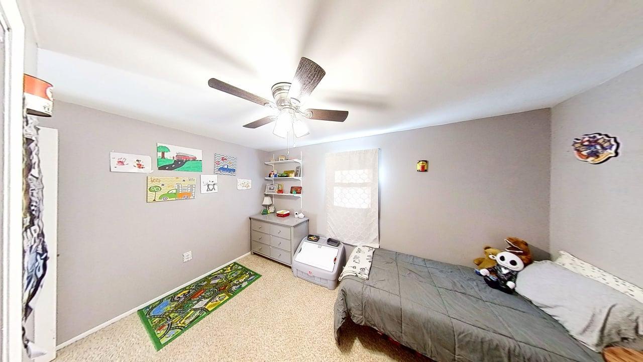 17 Greenlawn Drive Kankakee, IL 60901 - Photo 23 of 29 a bedroom with a bed and a chandelier