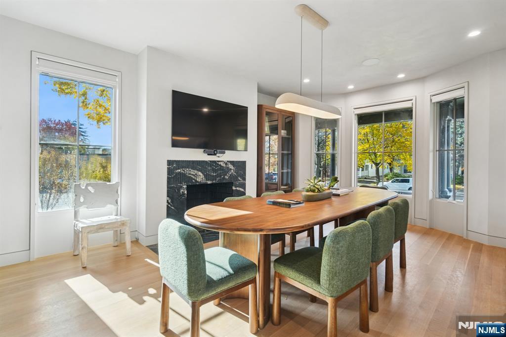 75 Midland Avenue Montclair, NJ 07042 - Photo 22 of 26 a dining room with furniture a chandelier and wooden floor