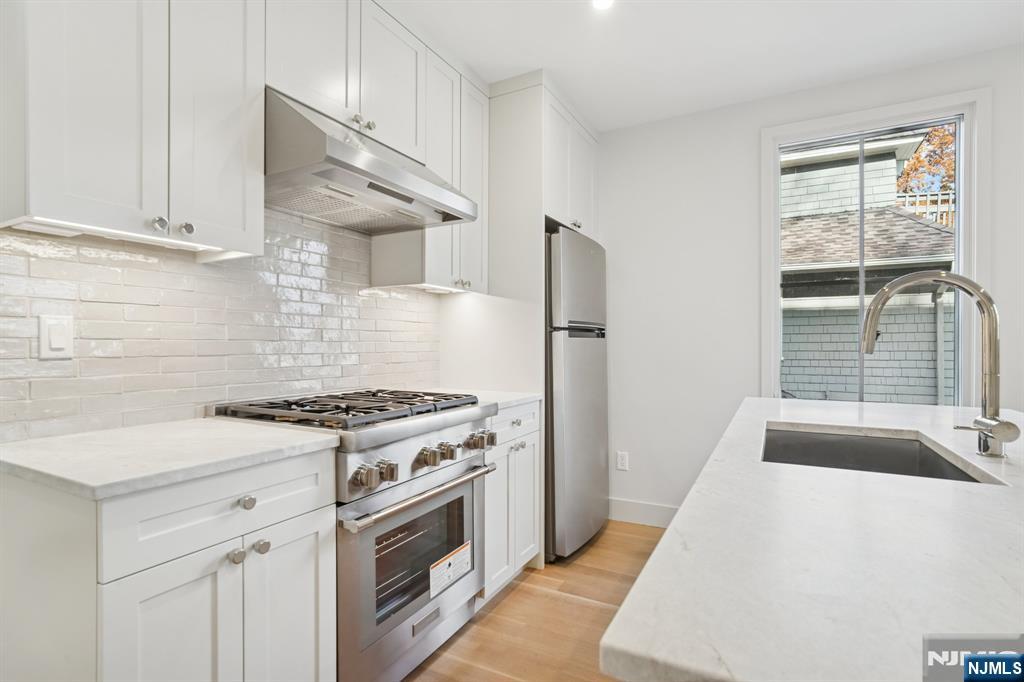 75 Midland Avenue Montclair, NJ 07042 - Photo 5 of 26 a kitchen with a stove a sink and a refrigerator