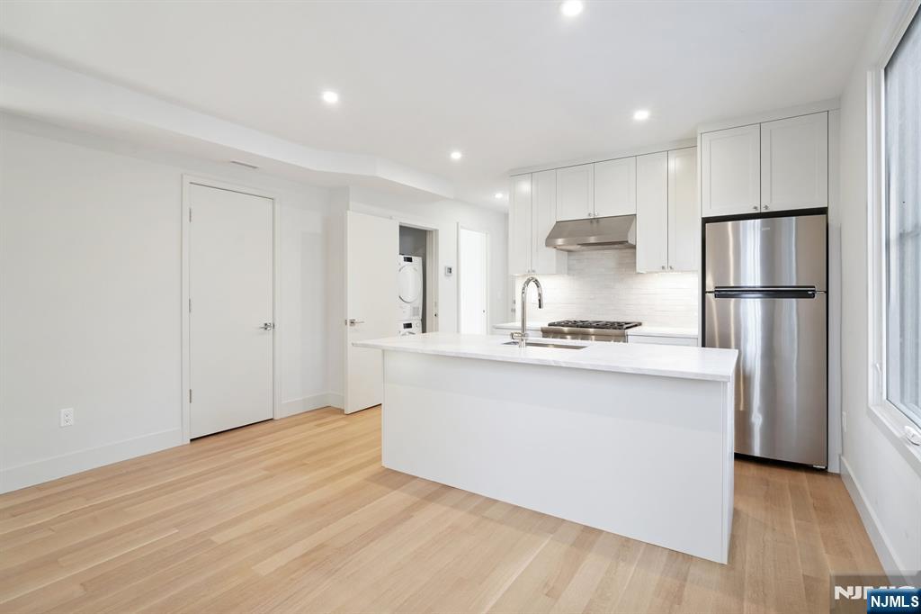75 Midland Avenue Montclair, NJ 07042 - Photo 7 of 26 a kitchen with white cabinets and refrigerator