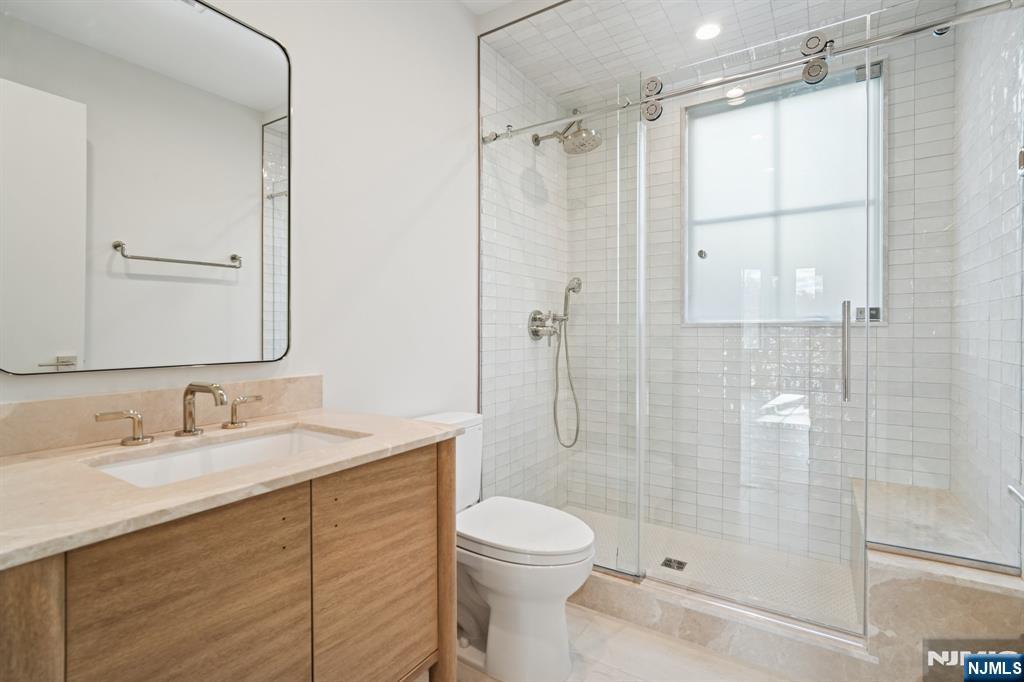 75 Midland Avenue Montclair, NJ 07042 - Photo 9 of 26 a bathroom with a sink a toilet and shower
