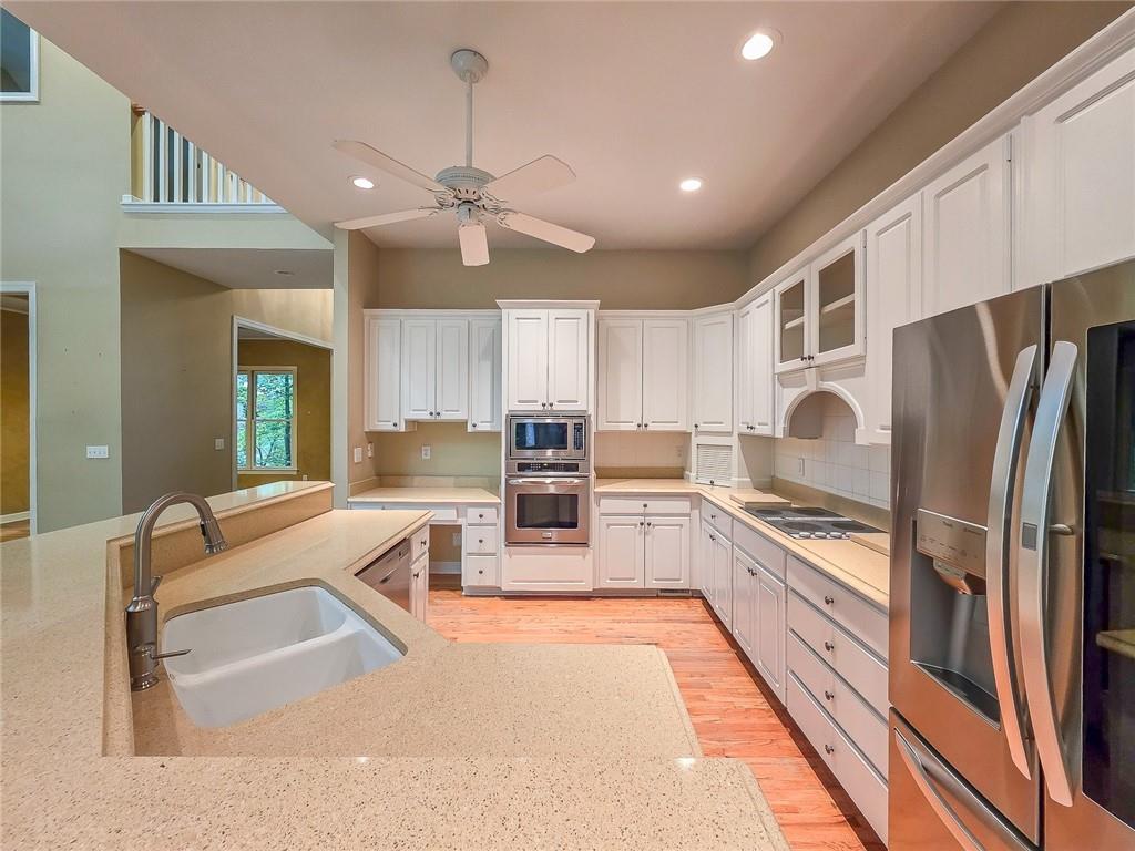 3712 Frederica Road Northwest Berkeley Lake, GA 30096 - Photo 16 of 49 a large kitchen with kitchen island a large counter top space stainless steel appliances and cabinets