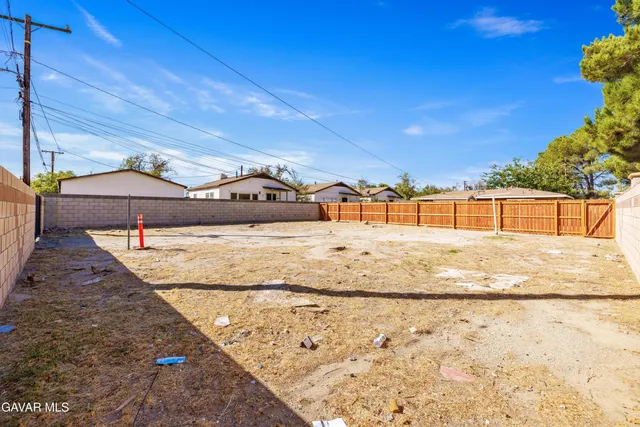 an aerial view of a house with a yard and large trees