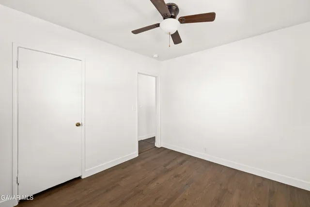 an empty room with wooden floor