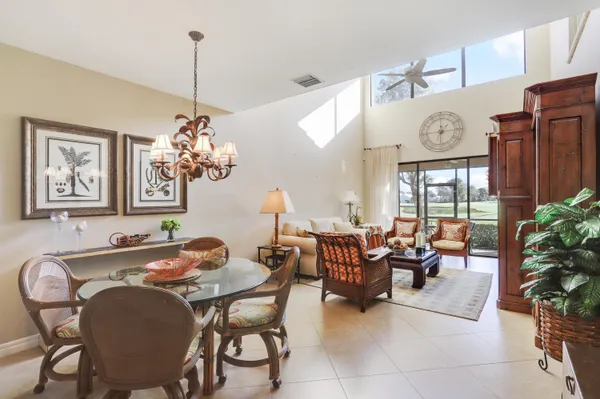 a living room with furniture a clock and a large window