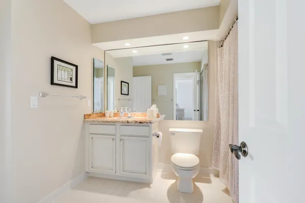 a bathroom with a window toilet and a shower curtain