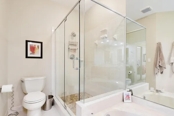 a spacious bathroom with a bathtub sink and mirror