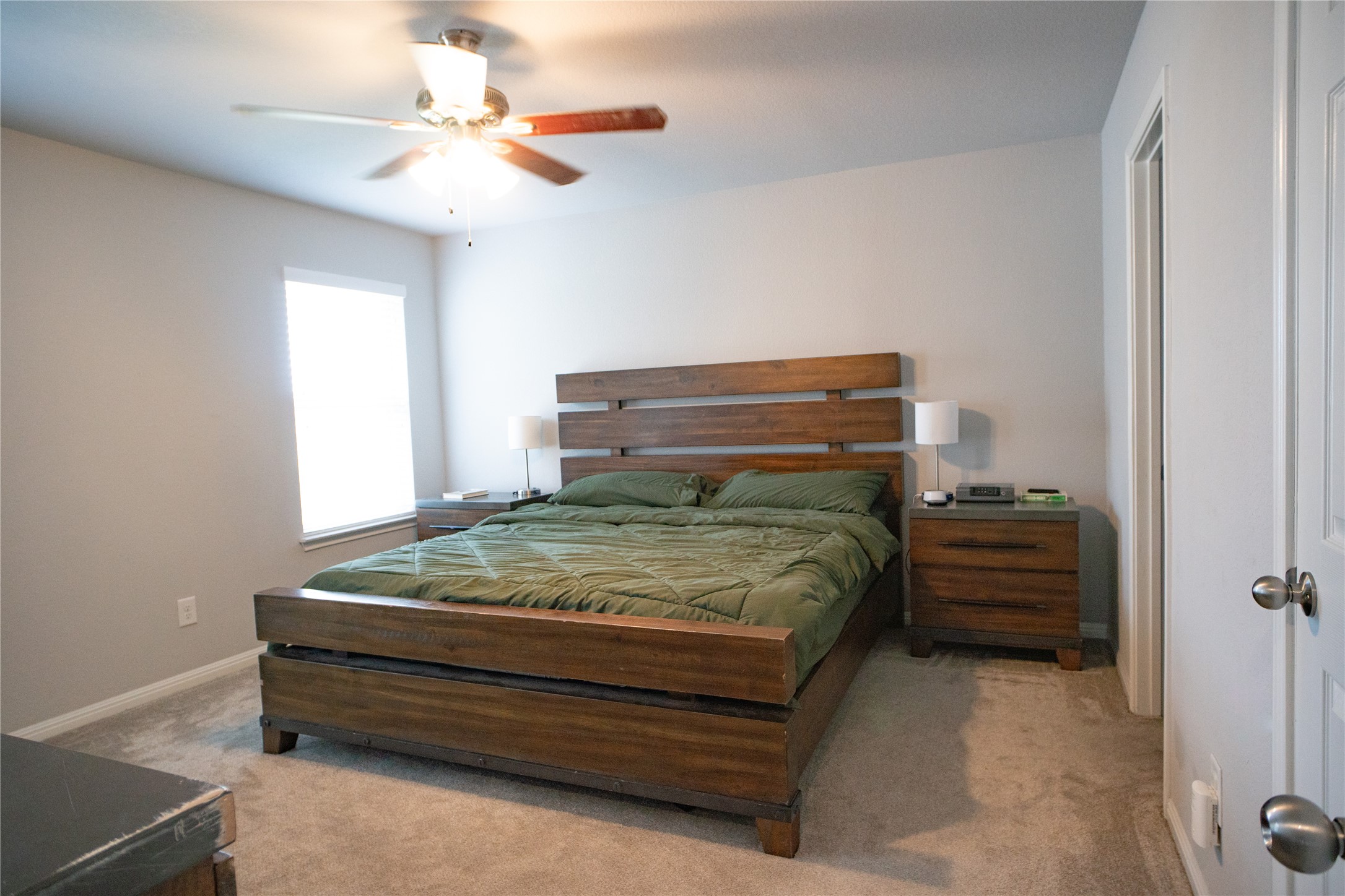 160 Shearwater Lane Leander, TX 78641 - Photo 19 of 24 a bedroom with a bed and a chandelier