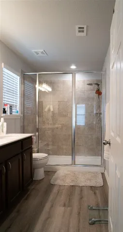 a bathroom with a shower a toilet and sink
