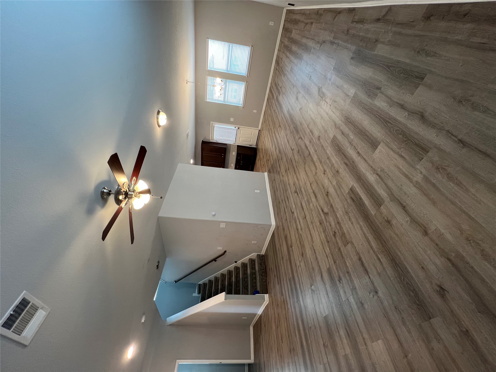 160 Shearwater Lane Leander, TX 78641 - Photo 4 of 24 a view of an empty room with wooden floor and a ceiling fan