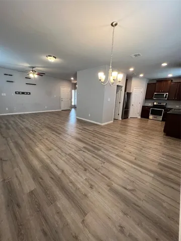 a view of a room with stairs and a wooden floor