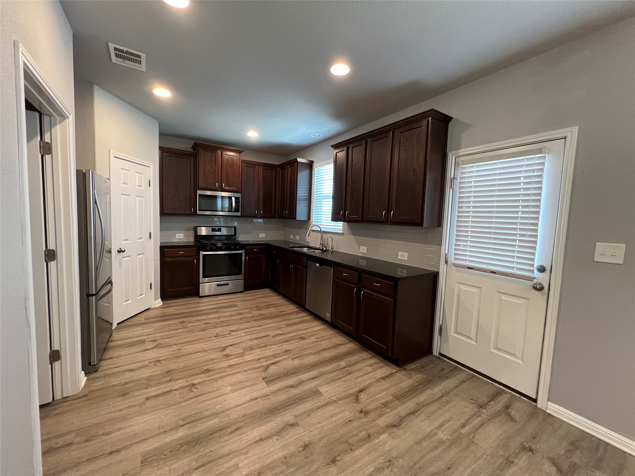 160 Shearwater Lane Leander, TX 78641 - Photo 8 of 24 a kitchen with stainless steel appliances granite countertop a refrigerator and a stove top oven