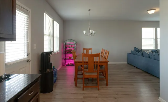 a dining room with furniture and wooden floor