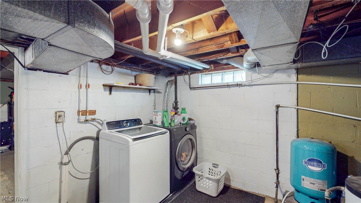 3659 Morrow Road Kent, OH 44240 - Photo 31 of 39 Basement utility area featuring a washer and dryer, block wall construction, exposed ceiling joists, and a glass block window