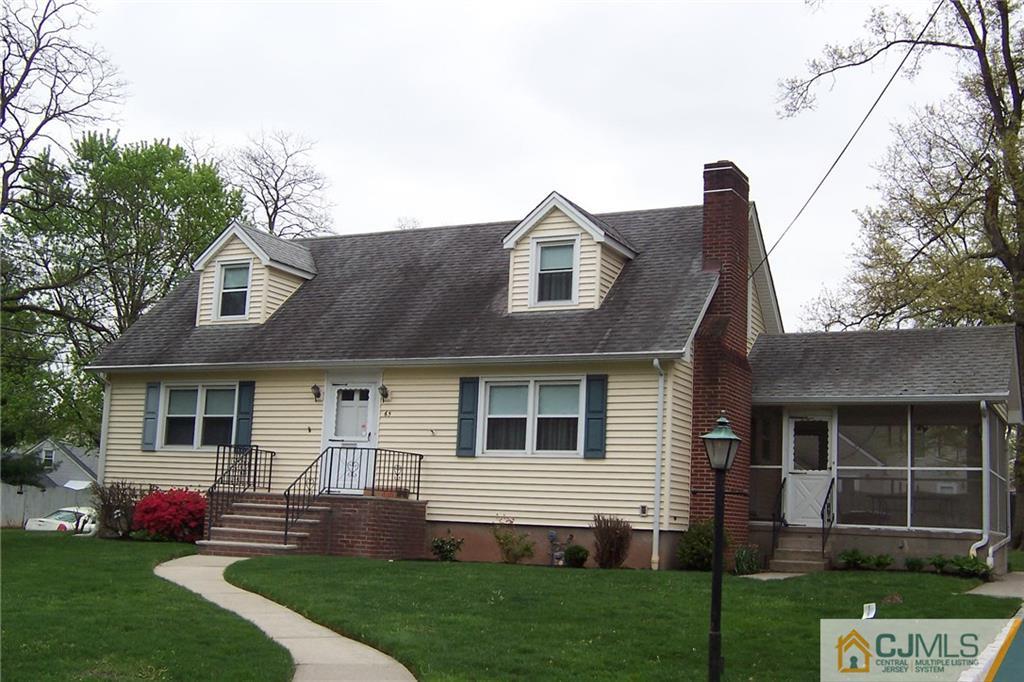 65 East Cliff Road Colonia, NJ 07067 - Photo 1 of 25 a front view of a house with a garden and yard