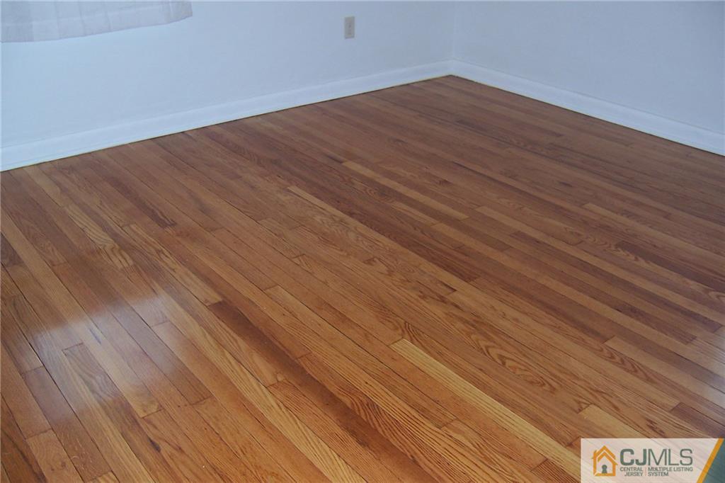 65 East Cliff Road Colonia, NJ 07067 - Photo 12 of 25 a view of an empty room with wooden floor
