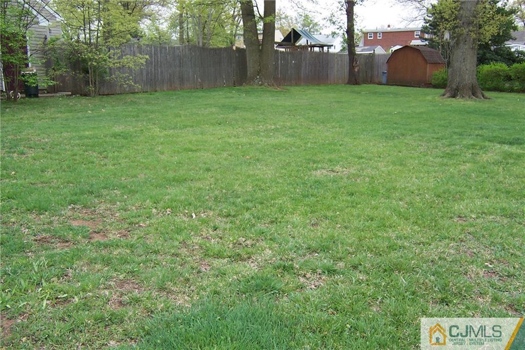 65 East Cliff Road Colonia, NJ 07067 - Photo 22 of 25 a view of a yard with a house and trees in the background