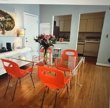 a dining room with furniture and wooden floor
