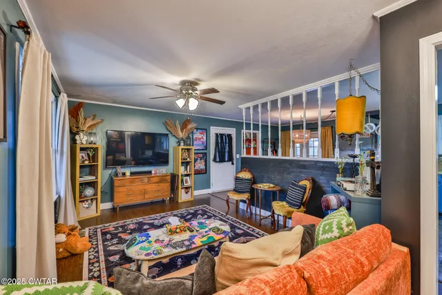 a living room with furniture fireplace and a window