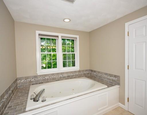 2 Conifer Hill Road Chelmsford, MA 01824 - Photo 23 of 32 a white bath tub sitting in a bathroom next to a window