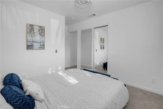 a bedroom with a bed and a couch