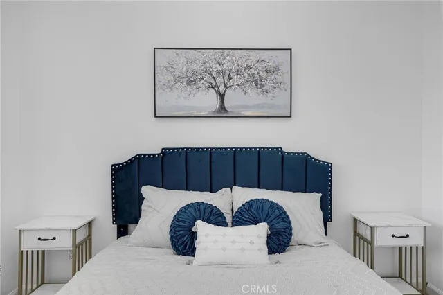 a bedroom with a large bed and a couch