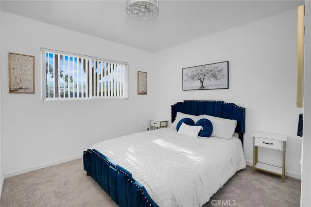 a bedroom with a large bed and a window